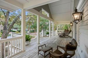 an empty porch with rocking chairs and windows at SM05: 5 Silver Moss in Kiawah Island