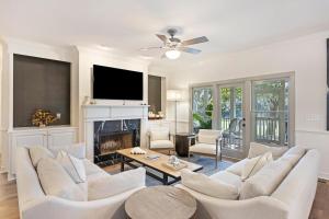 a living room with white furniture and a fireplace at SM05: 5 Silver Moss in Kiawah Island