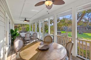 a porch with a wooden table and chairs at SM05: 5 Silver Moss in Kiawah Island