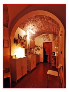 a kitchen with an archway and a table and chairs at Casa GALILEO- Antiche Dimore Pisane in Pisa