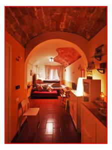 a kitchen and living room with a couch and a table at Casa GALILEO- Antiche Dimore Pisane in Pisa