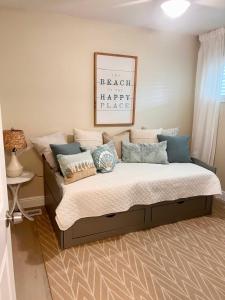 a bed with pillows on it in a bedroom at Coastal Countdown Relaxed Townhome Near Beach and Rockets in Cape Canaveral
