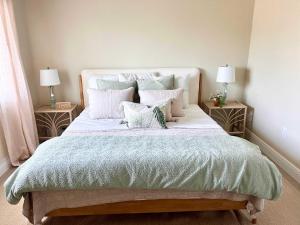 a bedroom with a large bed with pillows at Coastal Countdown Relaxed Townhome Near Beach and Rockets in Cape Canaveral