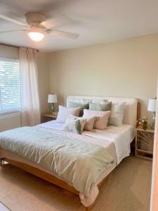 a bedroom with a large bed with pillows on it at Coastal Countdown Relaxed Townhome Near Beach and Rockets in Cape Canaveral