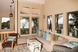 a living room with a couch and some windows at Calypso in Lincoln City