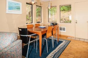 a dining room with a wooden table and chairs at Calypso in Lincoln City