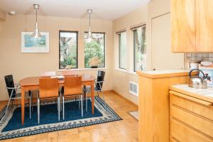 a kitchen and dining room with a table and chairs at Calypso in Lincoln City +18 photos