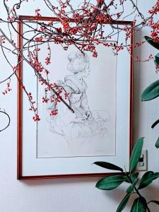 a drawing of a girl on a wall with flowers at Sapporoの実家 B&B Yoshida in Sapporo