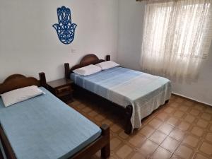 Postel nebo postele na pokoji v ubytování Casa Térrea Espaçosa Centro , Bertioga-Pertinho da Praia