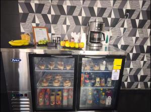 a refrigerator filled with lots of different types of drinks at La Casona Que Encanta antes The Andy Hotel in Querétaro