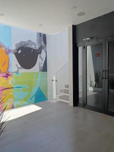 a room with a painting on the wall at La Casona Que Encanta antes The Andy Hotel in Querétaro