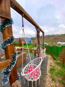 a swing in a yard with christmas decorations at Villa Konezal in Ferizaj