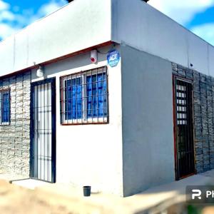 een wit gebouw met twee ramen en een deur bij Mateo y Stella 3 in Bialet Massé