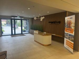 a lobby with a reception desk in a building at Apartament Morzlive in Ustronie Morskie