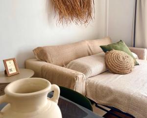 a living room with a couch and a vase on a table at Anahata Homes in Antigua