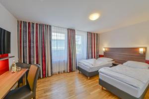 Postel nebo postele na pokoji v ubytování City Hotel Wetzlar