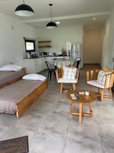 a living room with two beds and a kitchen at La Elenita Tandil in Tandil