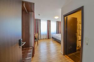 Postel nebo postele na pokoji v ubytování City Hotel Wetzlar