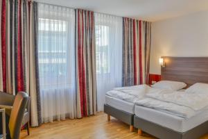 Postel nebo postele na pokoji v ubytování City Hotel Wetzlar