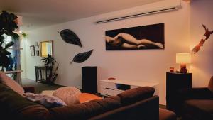 a living room with a couch and a painting on the wall at Stylish Home within Central Wellington - Free Parking in Wellington
