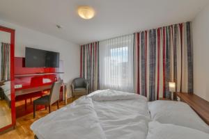 Postel nebo postele na pokoji v ubytování City Hotel Wetzlar