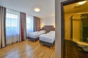 Postel nebo postele na pokoji v ubytování City Hotel Wetzlar