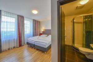 Postel nebo postele na pokoji v ubytování City Hotel Wetzlar