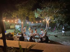 a group of people sitting around a fire pit at night at Casa Balam Sisal in Sisal