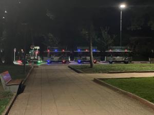 three fire trucks parked in a parking lot at night at Chalet villa QUE POUR LES FAMILLES in Imouzzer du Kandar