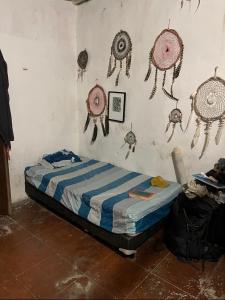 a bedroom with a bed with decorations on the wall at Casa Balam Sisal in Sisal
