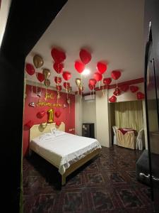 a bedroom with a bed with red hearts on the ceiling at Hotel Arena Caliente in Playas