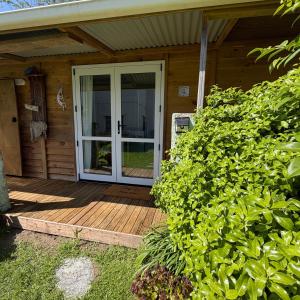 a sliding glass door on a porch of a house at Captains Quarters in Ohope Beach