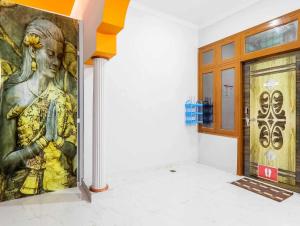 a painting of a woman on a wall in a room at Hotel O Prime Stayzz in Kaliānpur +68 photos