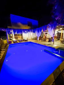 a large swimming pool at night with blue illumination at Villa Naylamp loft 10 beach pocitas in Puerto Máncora