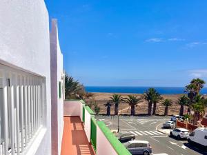 a balcony with a view of a parking lot and the ocean at Anahata Homes in Antigua