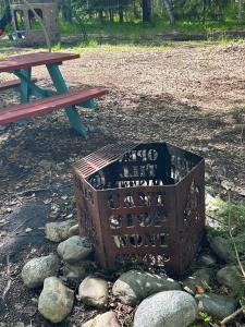 a basket sitting on the ground next to a picnic table at Camo Cabin #4 in Houston