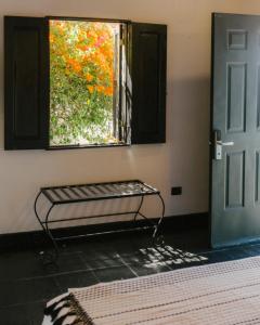 a room with a bench in front of a window at Hotel MariaBonita San Miguel de Allende in San Miguel de Allende