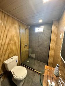 a bathroom with a shower and a toilet and a glass table at Serendipia in Maldonado