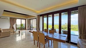a dining room with a table and chairs in a room at Vivo Villas - Villa Vivo in Uluwatu