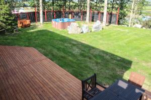 a deck with a bench and a pool and grass at Hestasport Apartment in Varmahlid +20 photos
