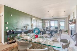 a living room with a glass table and chairs at Sunsets at the Shoreline in Newport