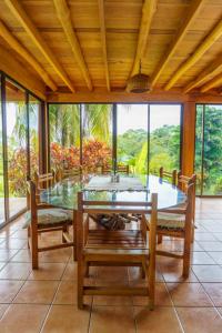 a dining room with a glass table and chairs at Jodokus Inn in Montezuma