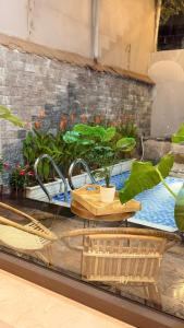 a counter with a sink with plants on it at Solia Villa in Da Nang