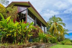 a house with a bunch of plants in front of it at Jodokus Inn in Montezuma