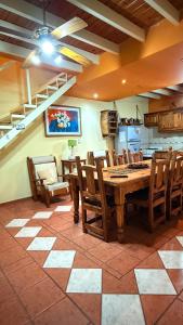 a dining room with a wooden table and chairs at Casa sonia in San Rafael