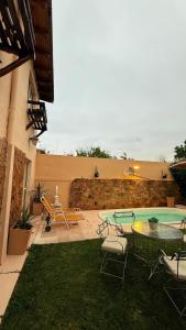 a patio with a table and chairs and a pool at Casa sonia in San Rafael +8 photos