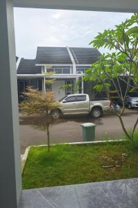 Un camion parcheggiato in un parcheggio di fronte a una casa. di Cluster Springwood a Pontianak