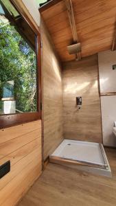 an empty sauna with a window in a wooden room at Octógono Soñado Lodge in El Boquerón