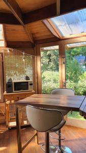 a dining room with a large wooden table and chairs at Octógono Soñado Lodge in El Boquerón