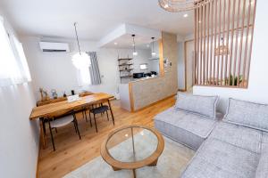 a living room with a table and a couch at Guel Palacio in Miyako-jima